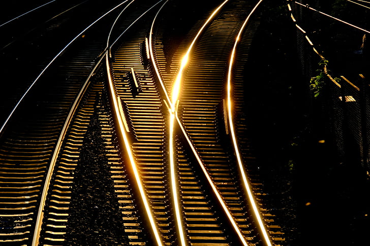 Railway tracks at night under city lights